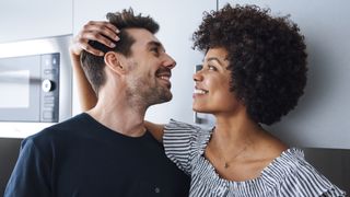 a man and woman looking at each other's hair