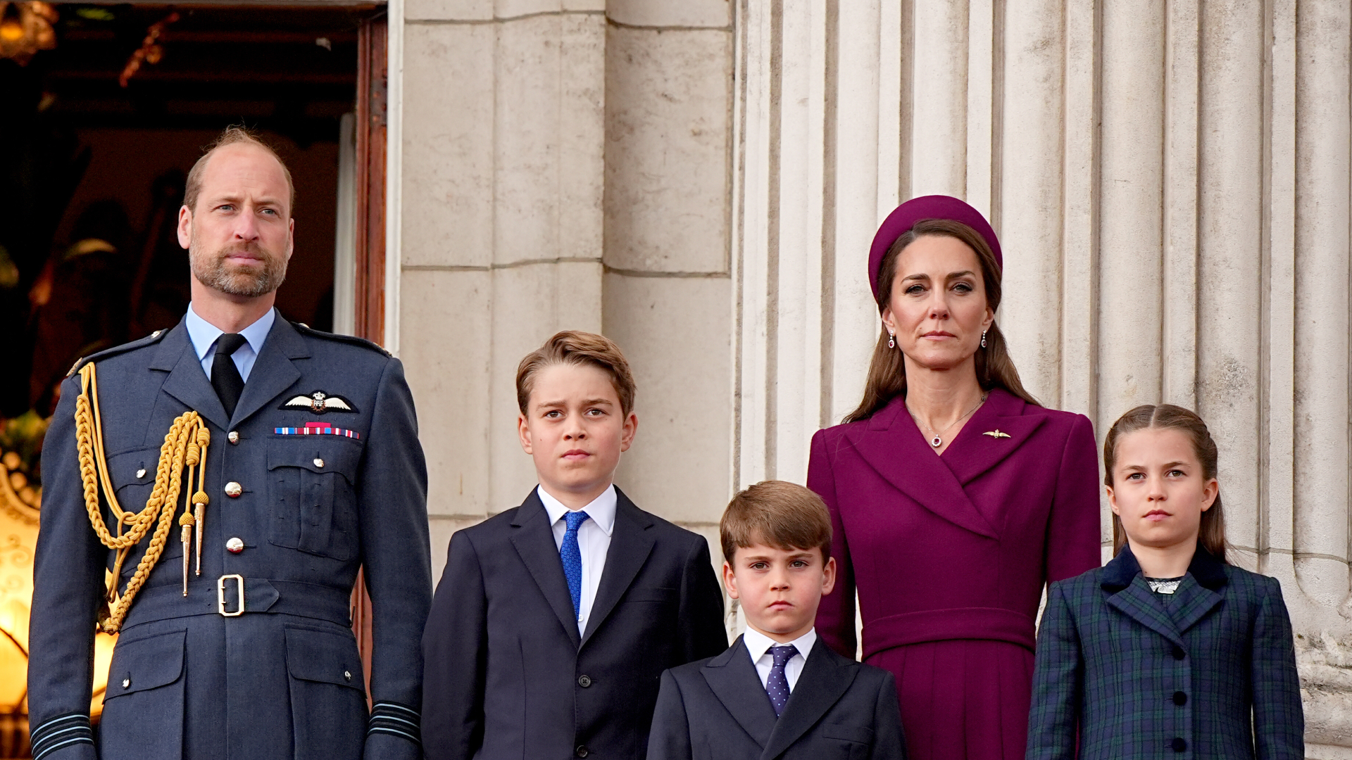 Prince George, Princess Charlotte, and Prince Louis stand with their parents on the balcony of Buckingham Palace.