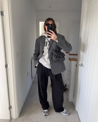 The influencer wore a gray blazer with black pants and sneakers