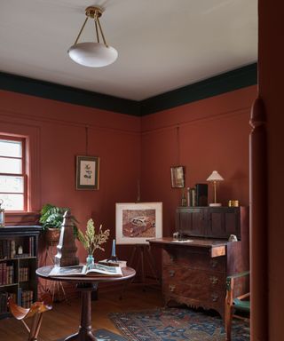 library room with dark red walls and antique furniture