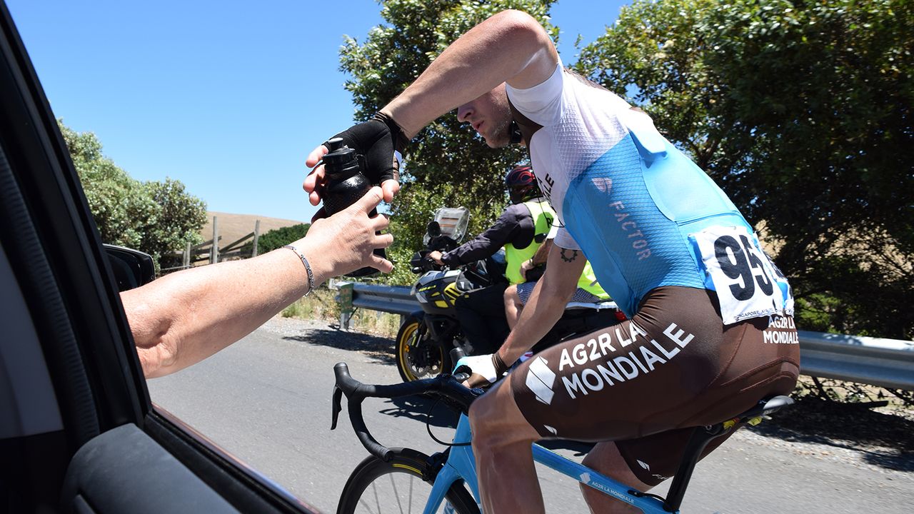 Nans Peters drops back for more bidons from Laurent Biondi