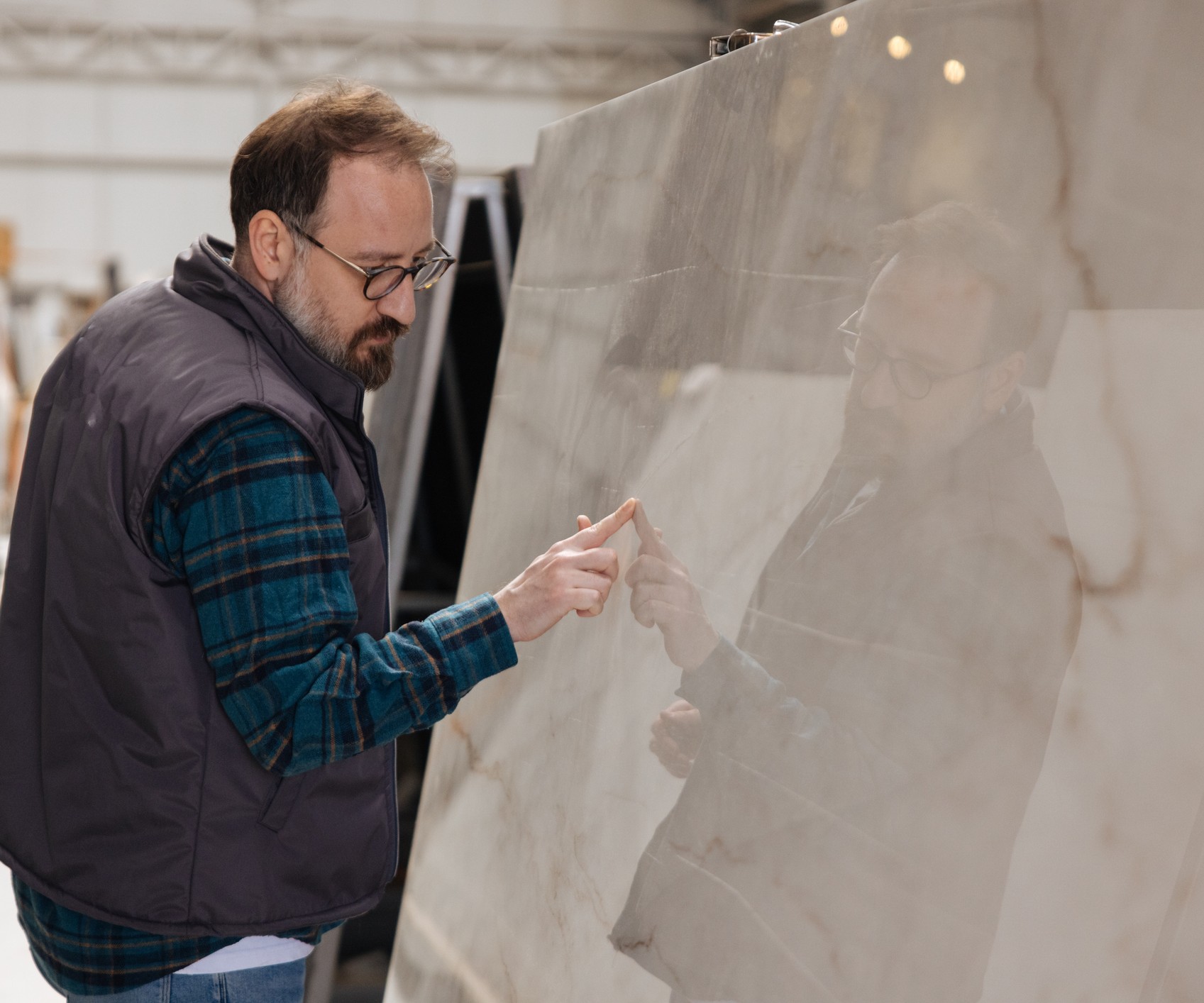 A man inspecting a marble worksurface