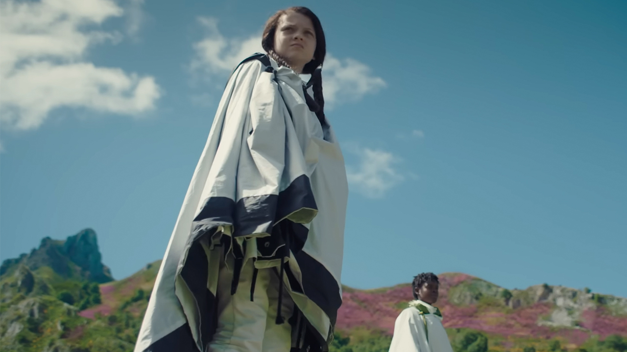 A girl in a white robe in Sunrise on the Reaping