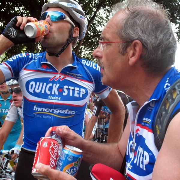 Dirk Nachtergaele hands out drinks to his riders