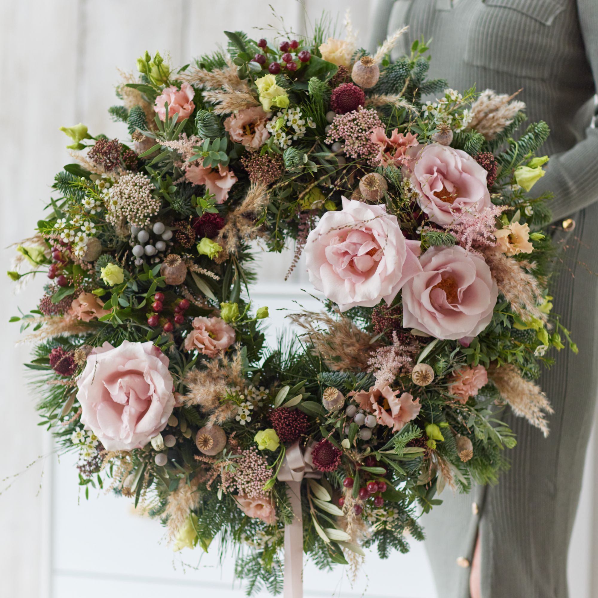 A christmas wreath in muted pinks and lilacs