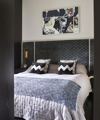 A teenage boys bedroom idea with black feature headboard with white moustache print and white walls