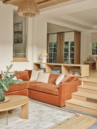 wood and white split level living room with orange sofa
