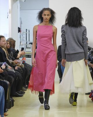 Woman in pink dress on Molly Goddard runway