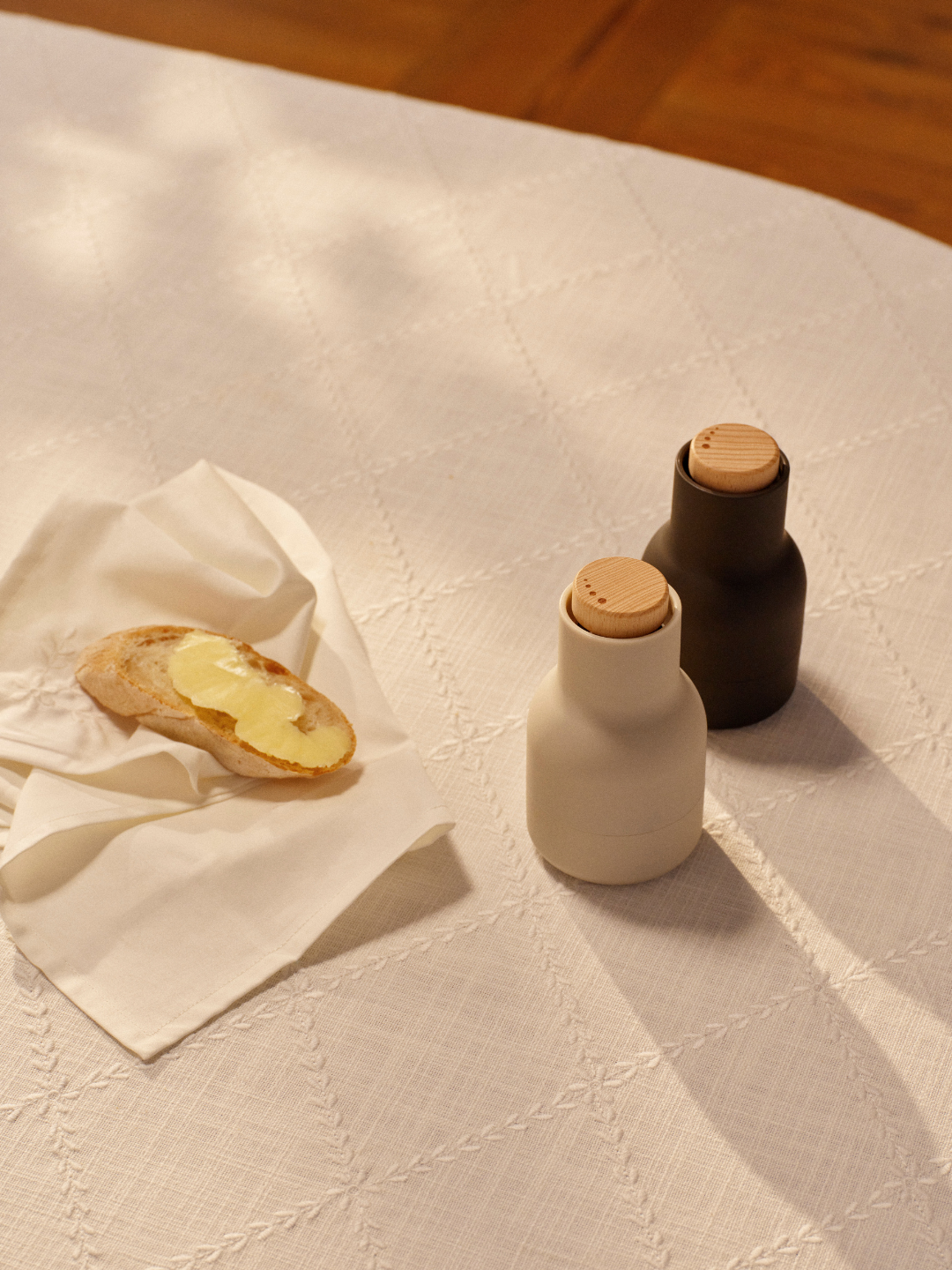 A pair of black and white salt and pepper grinders from Audo Copenhagen