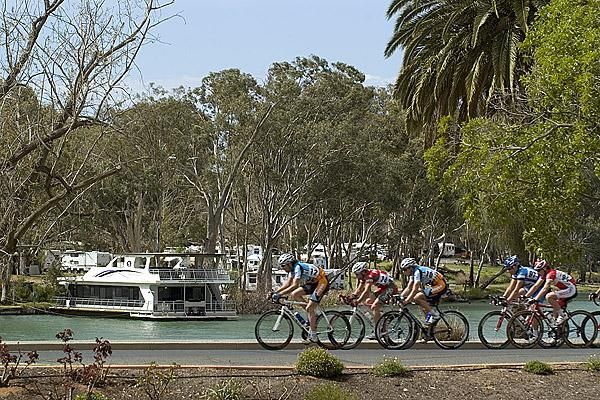 The lead group roll by the Murray River in Mildura during stage fourteen, the final stage of the Tour.