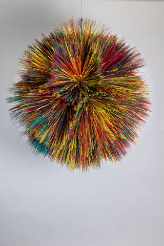 Hanging object featuring multicoloured broom fibers
