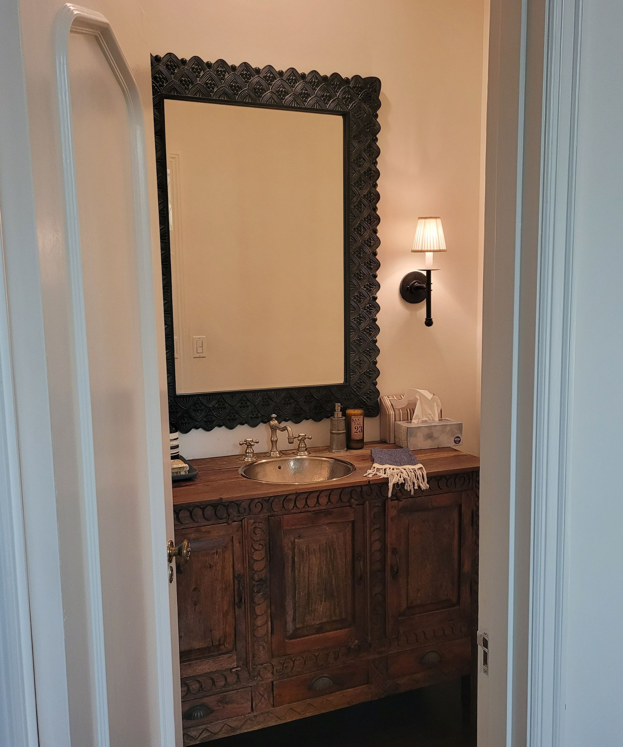 A before picture of a powder room with an antique wooden dresser