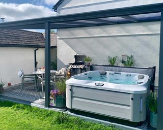 hydrolife hot tub with pergola and seating area