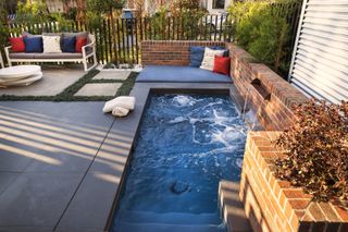 pool fence ideas: fence and brick wall surrounding pool