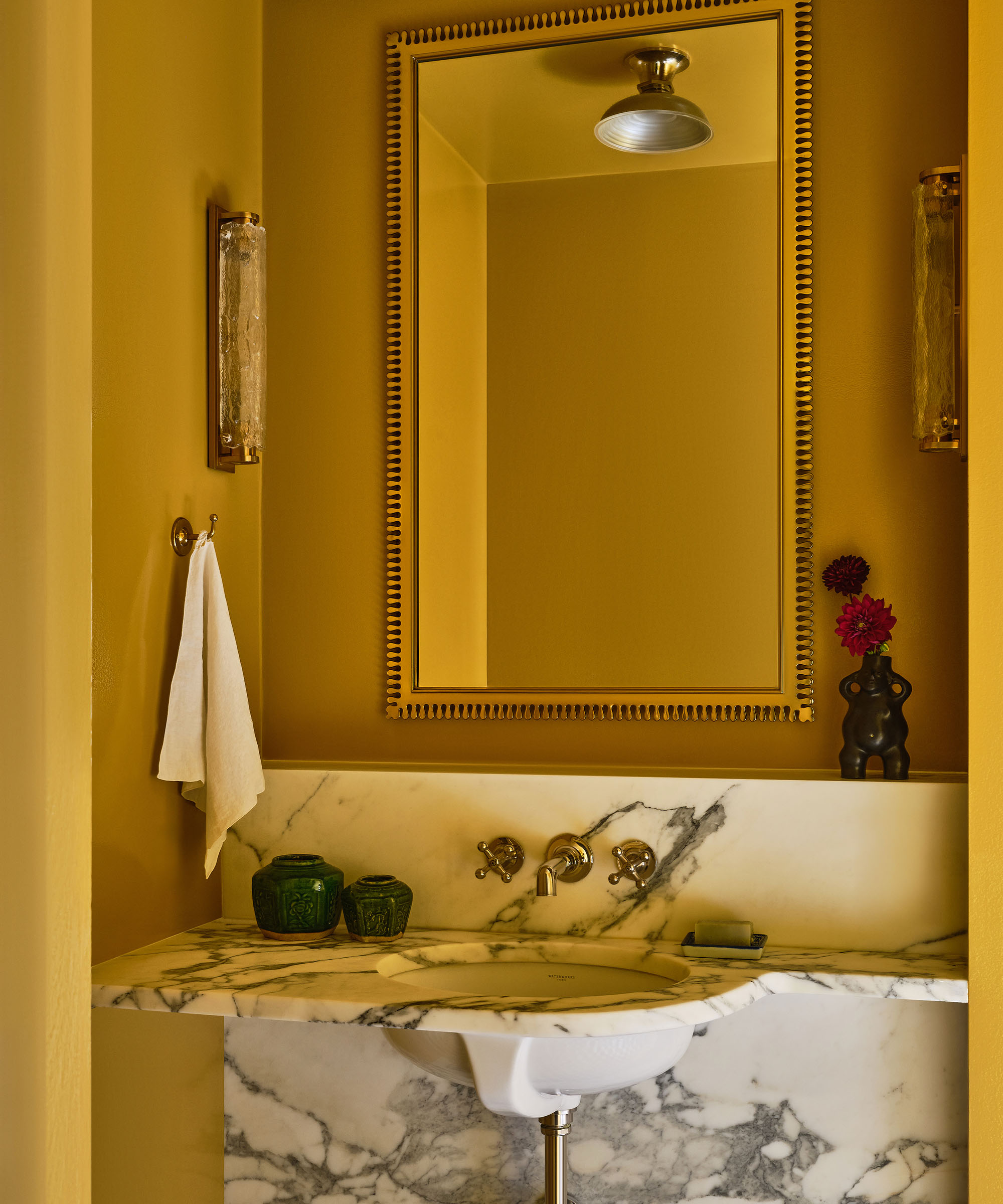 yellow powder room with marble vanity