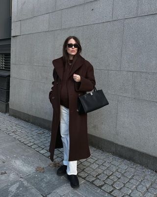 @annabelrosendahl wearing white jeans with brown coat