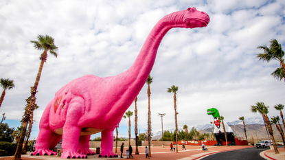 A pink dinosaur and a T-Rex dinosaur at the Cabazon Dinosaurs exhibit in Cabazon, California