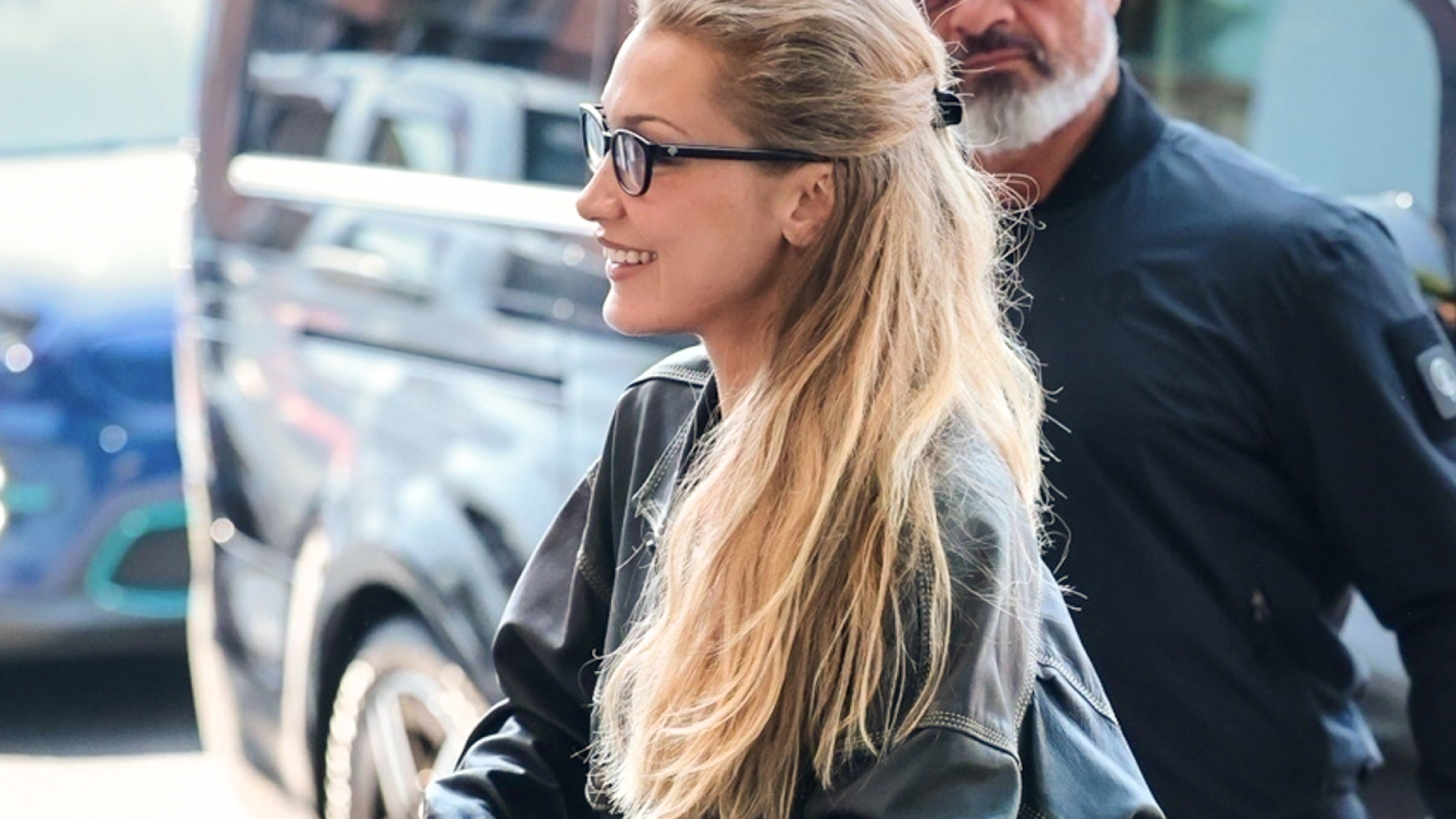 Bella Hadid wearing a leather jacket and nike sneakers