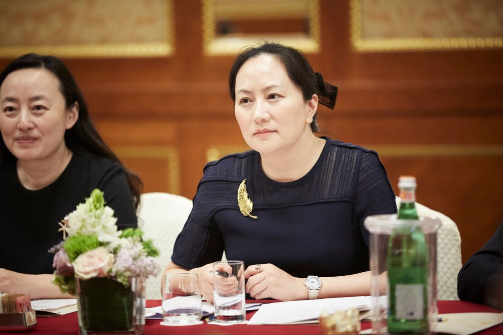 Meng Wanzhou at a table