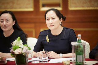 Meng Wanzhou at a table