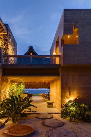 The house is built as a cluster of volumes on a secluded wind- and sea-swept spot in Zihuatanejo