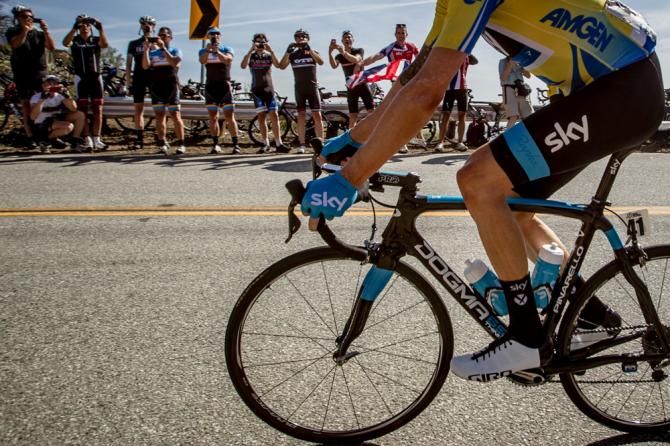 Fans watch as the race leader rolls past on the climb