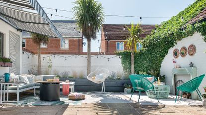 garden area with sofa and potted plants