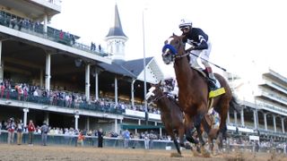 Authentic #18, ridden by jockey John Velazquez #18 crosses the finish line of the delayed Kentucky Derby in 2020.