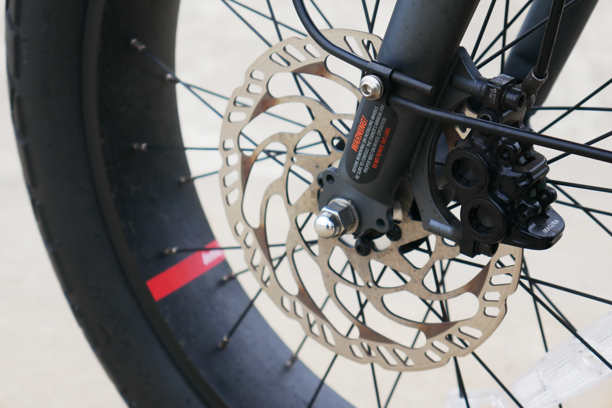 Benno RemiDemi XL against the backdrop of a concrete skatepark focused in on the Magura brakes caliper