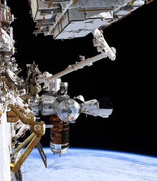 NASA astronaut Chris Cassidy snapped this photo of SpaceX's Crew Dragon vehicle docked with the International Space Station during a spacewalk with Bob Behnken on Friday, June 26, 2020.