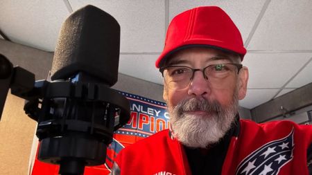 Videogame Voice actor Wes Johnson posed next to a studio microphone.