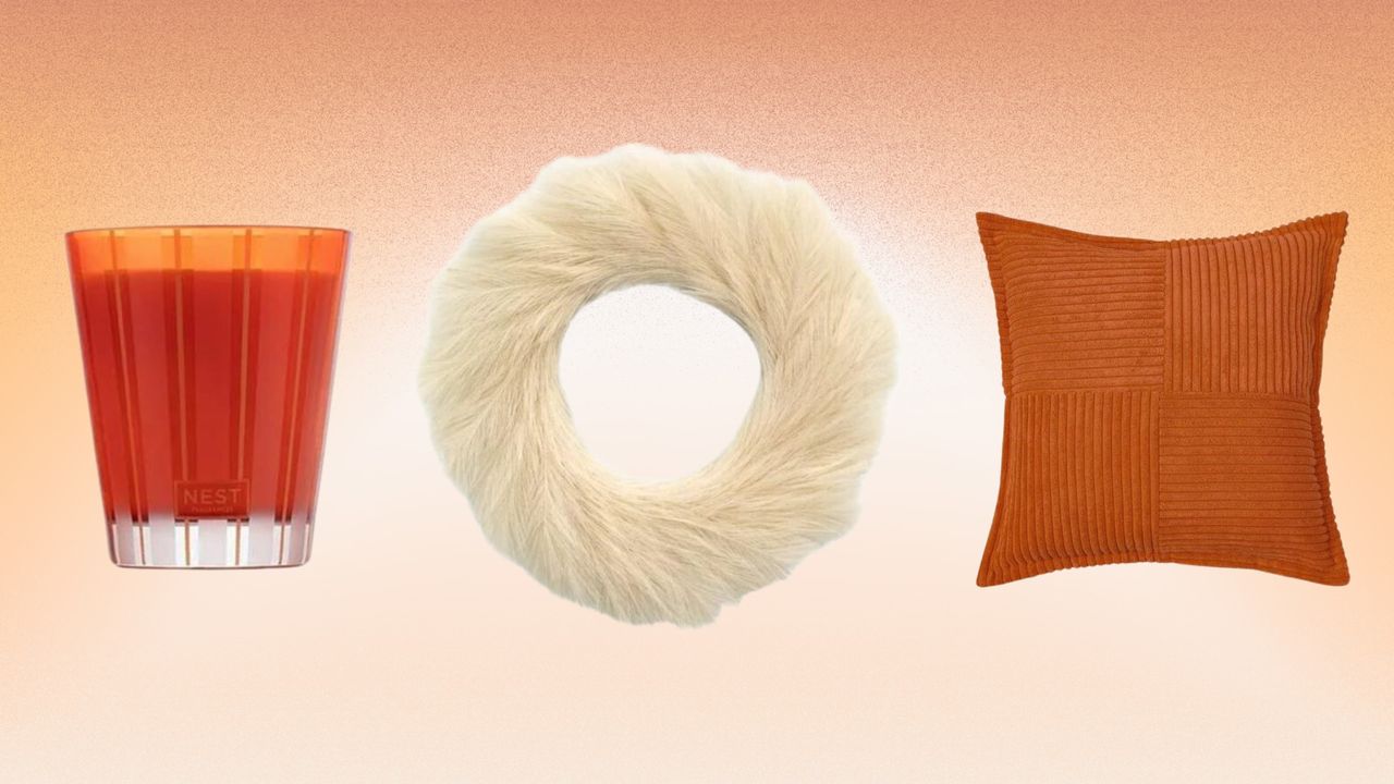 Orange candle, neutral wreath, and orange cushion on light orange background