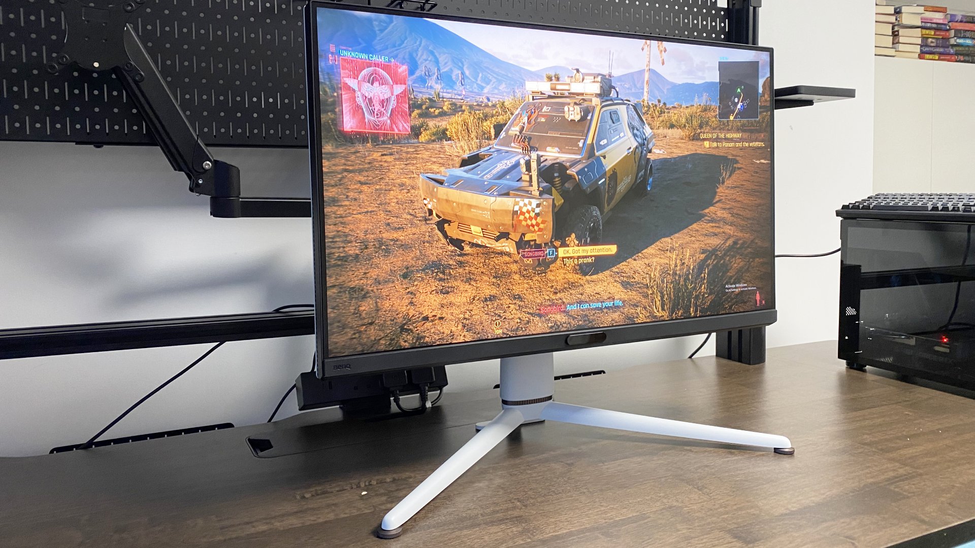 A photo of a BenQ Mobiuz EX321UX gaming monitor on a desk