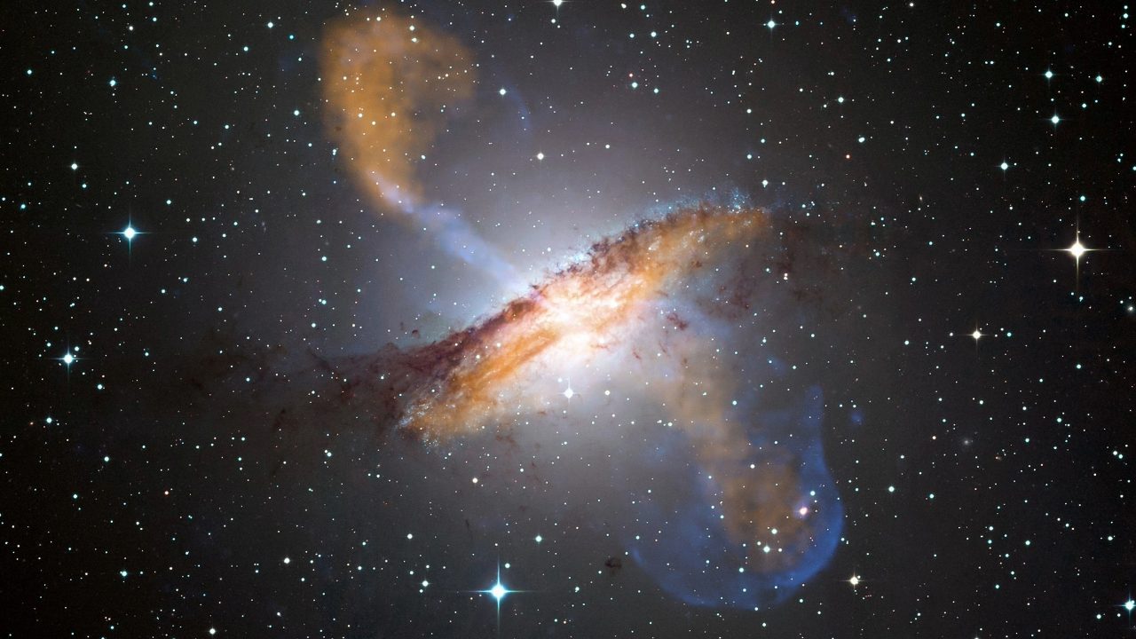 A glowing disk spews light out either horizontal end in the midst of a dark atmosphere full of stars