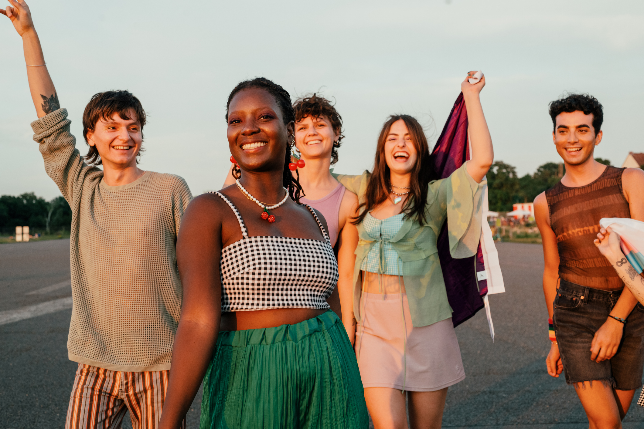 Group of Gen z people walking down road