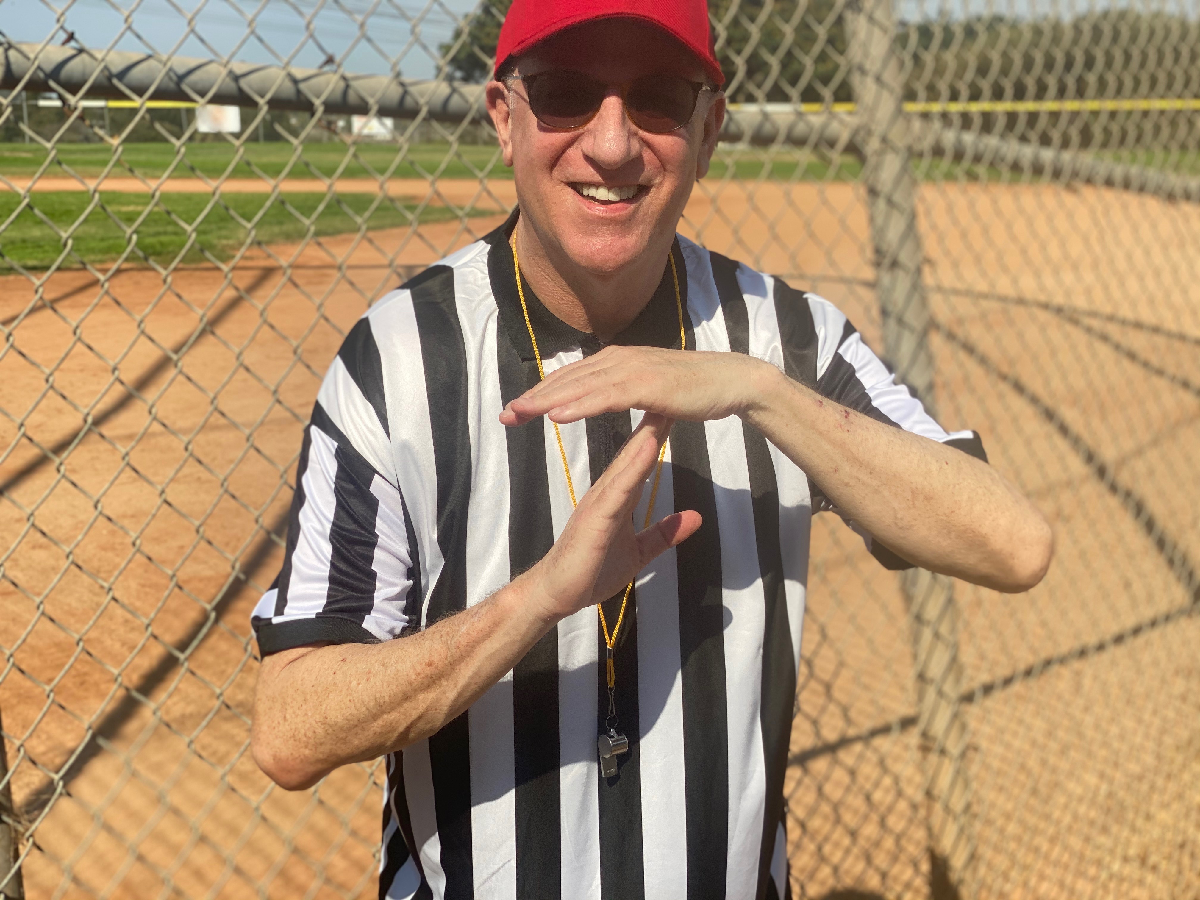 Tim Krass in a baseball umpire's garb.