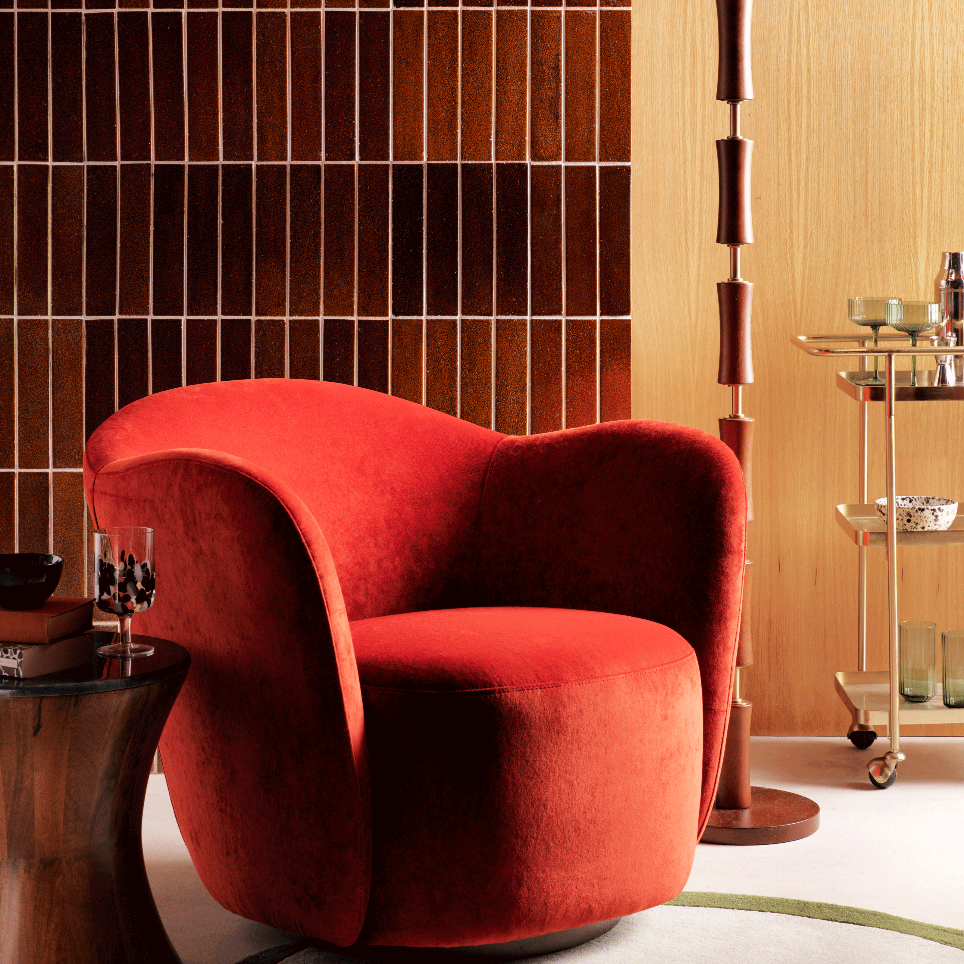 Habitat x Morris & Co red occasional chair in jazz bar set up with bamboo lamp