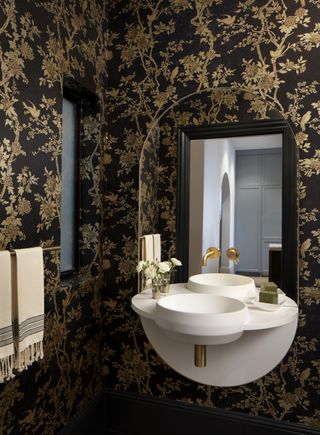 Bathroom with black and gold ornamental wallpaper