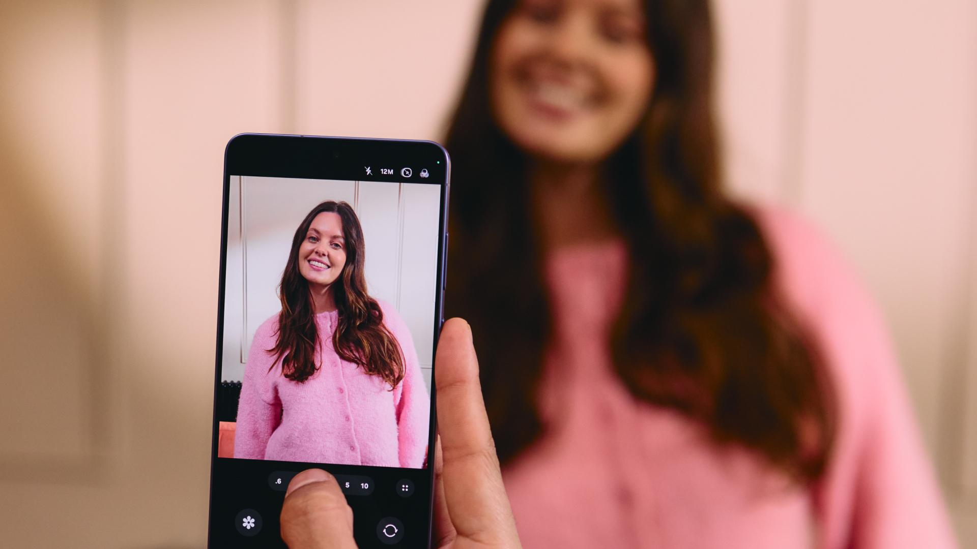 A person takes a photo in low light using the Samsung Galaxy S26 Ultra