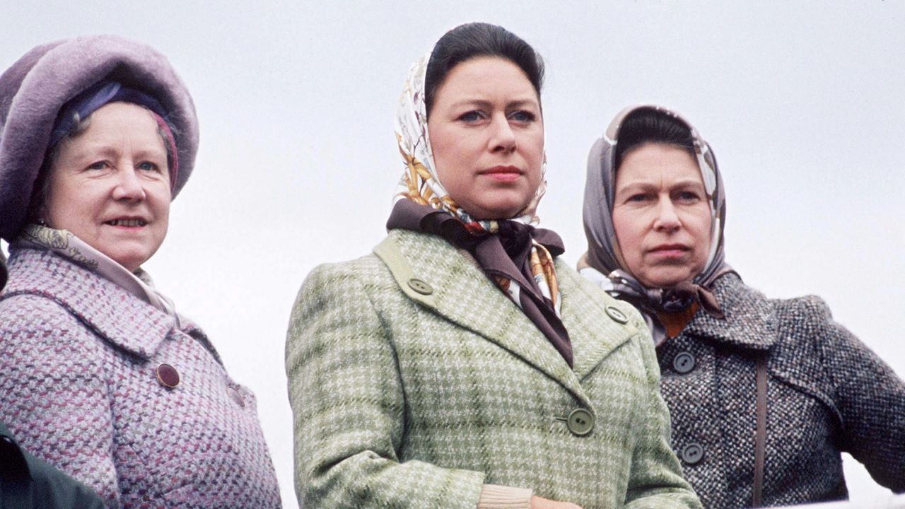 Queen Mother, Princess Margaret and Queen Elizabeth wearing tweed coats and head scarves looking serious 