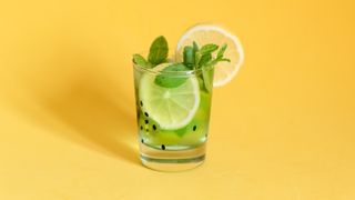 Cocktail on yellow background; alcohol could be the reason you keep waking up with a headache
