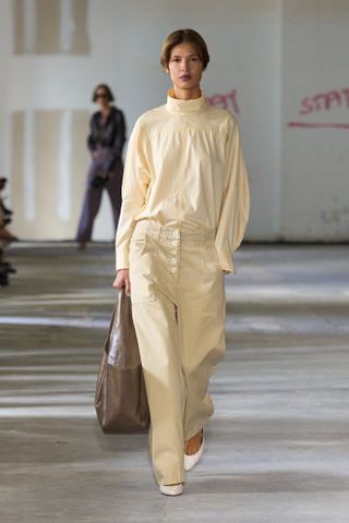 A model walks the Rachel Comey runway wearing the high neckline trend.