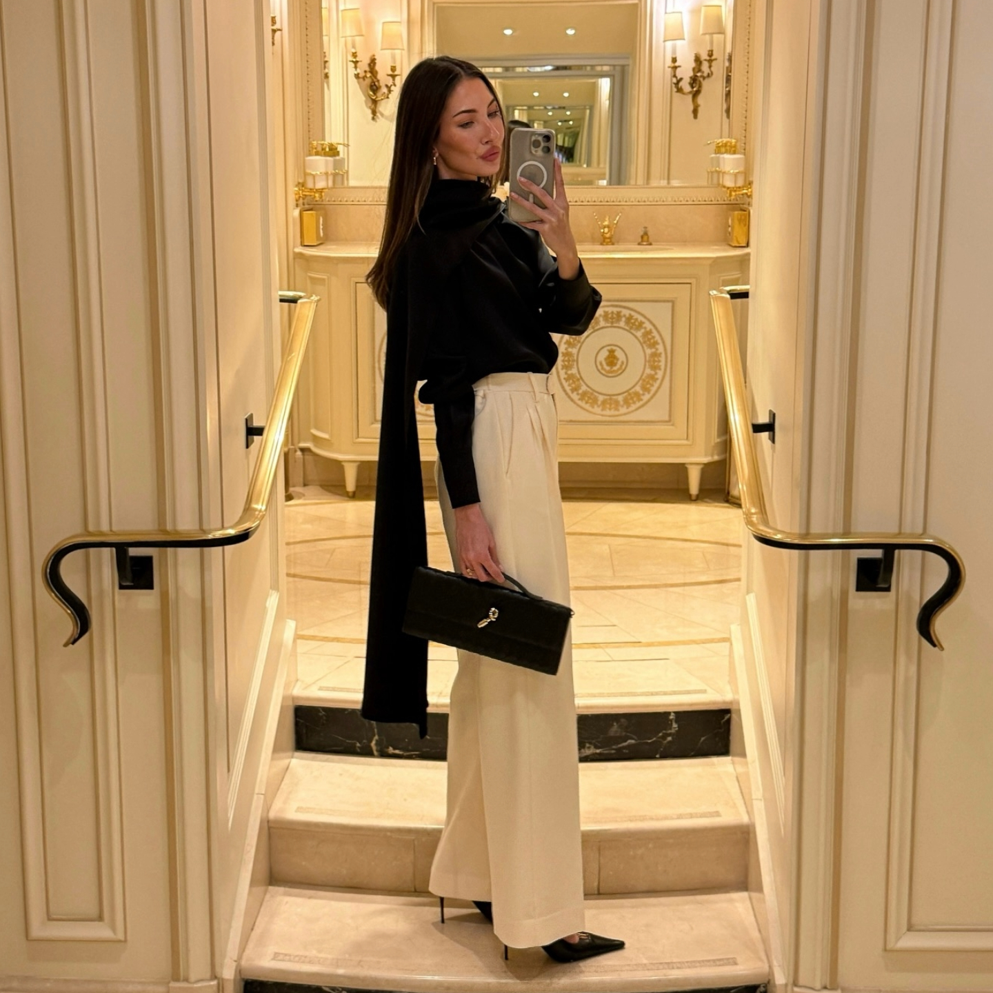 Felicia Akerstrom in a black silk top and white trousers