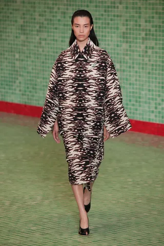 a model walks the Tory Burch spring 2025 runway