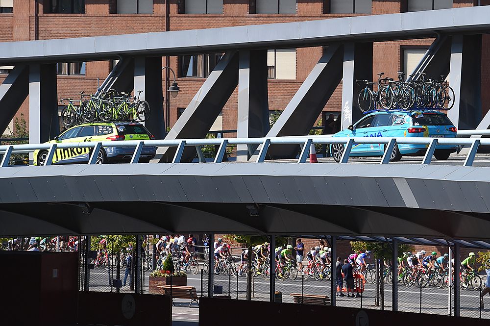 The field passes over a bridge at the Vuelta a Espana