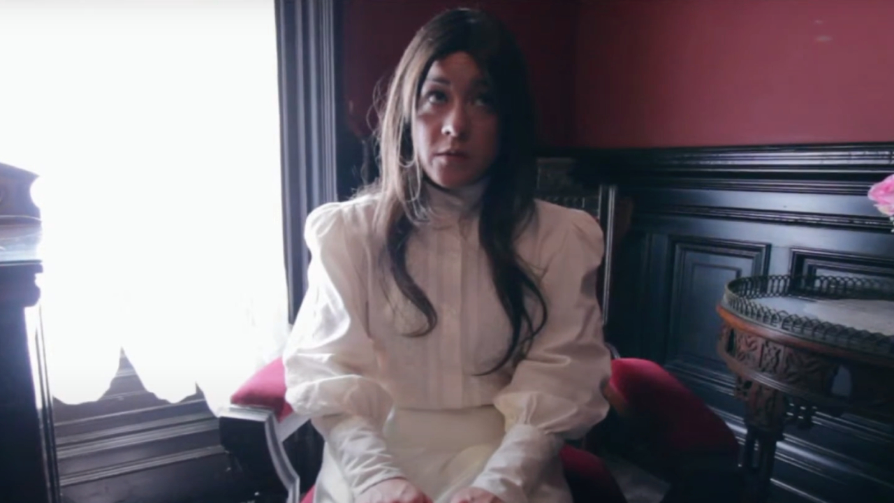 Anna Ishida as Emily sitting in a chair in I Am a Ghost