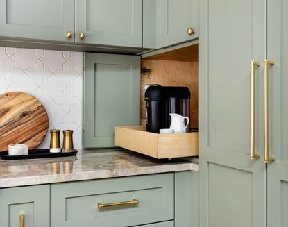 Green kitchen cabinets reveal pull out coffee maker