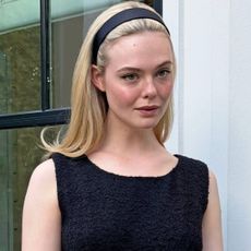 Elle Fanning Is So CBK-Coded in a '90s-Inspired Headband and a Vintage Balenciaga LBD with long blonde hair, sheer tights, and black patent pumps