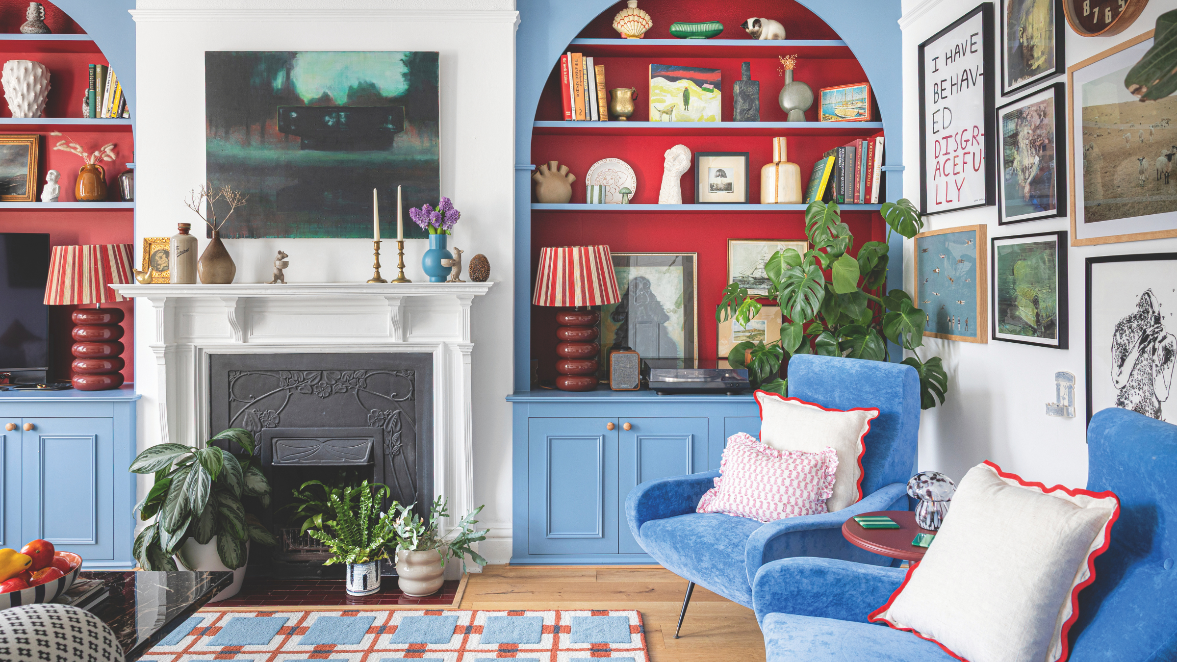 Blue built-in bookcases with red alcoves.