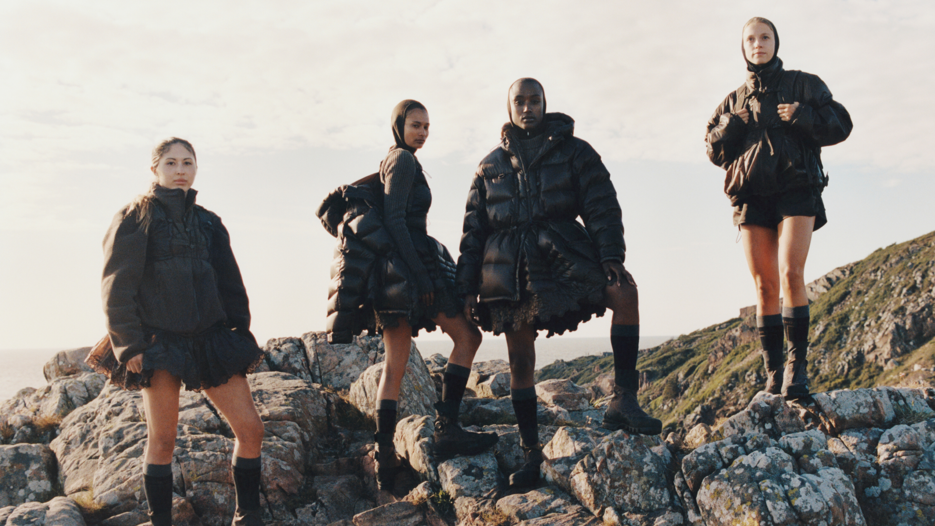 models wearing cecilie bahnsen x the north face on the side of a cliff